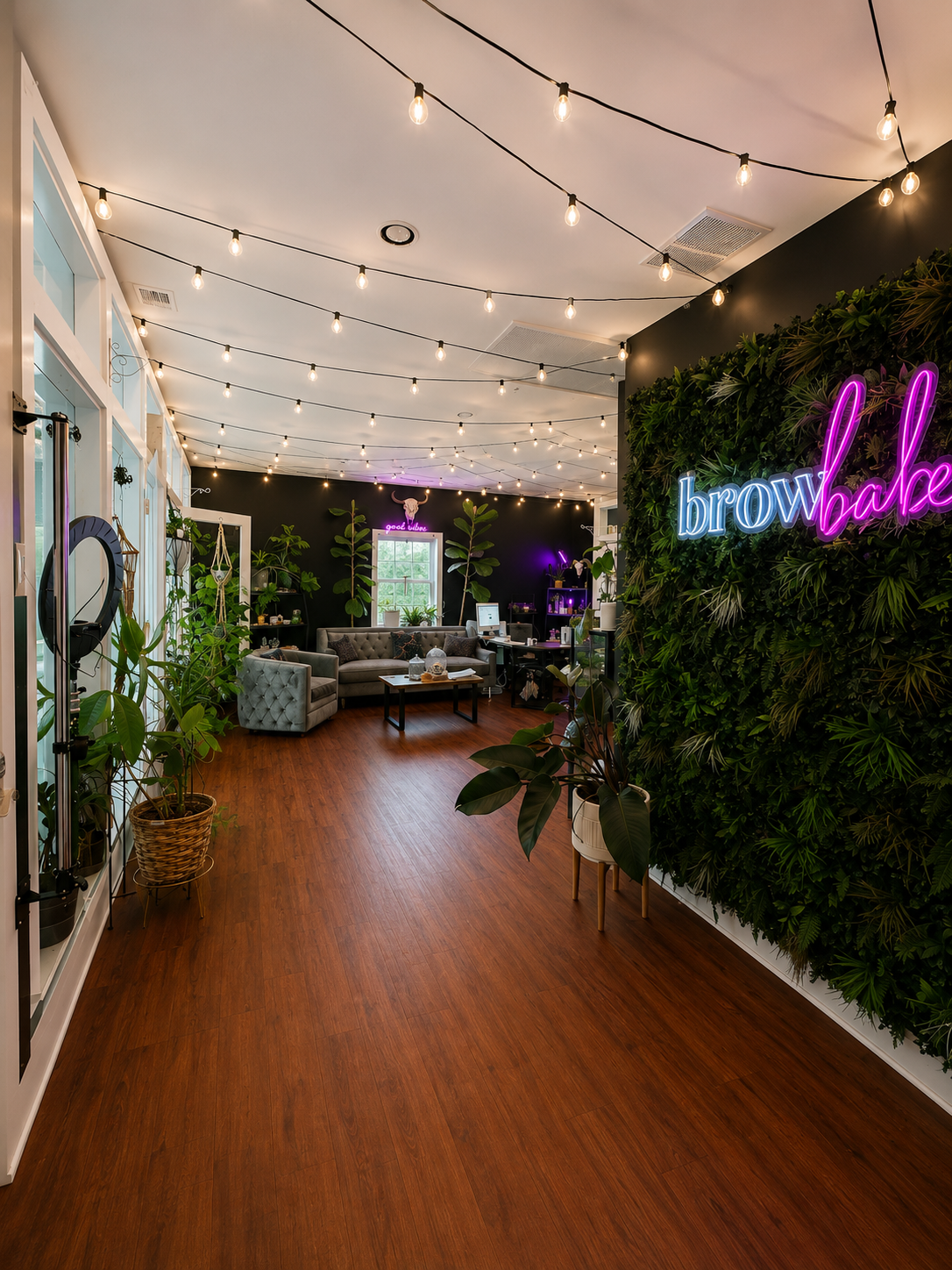 The Brow Babes — lobby with browbabes neon sign and string lights