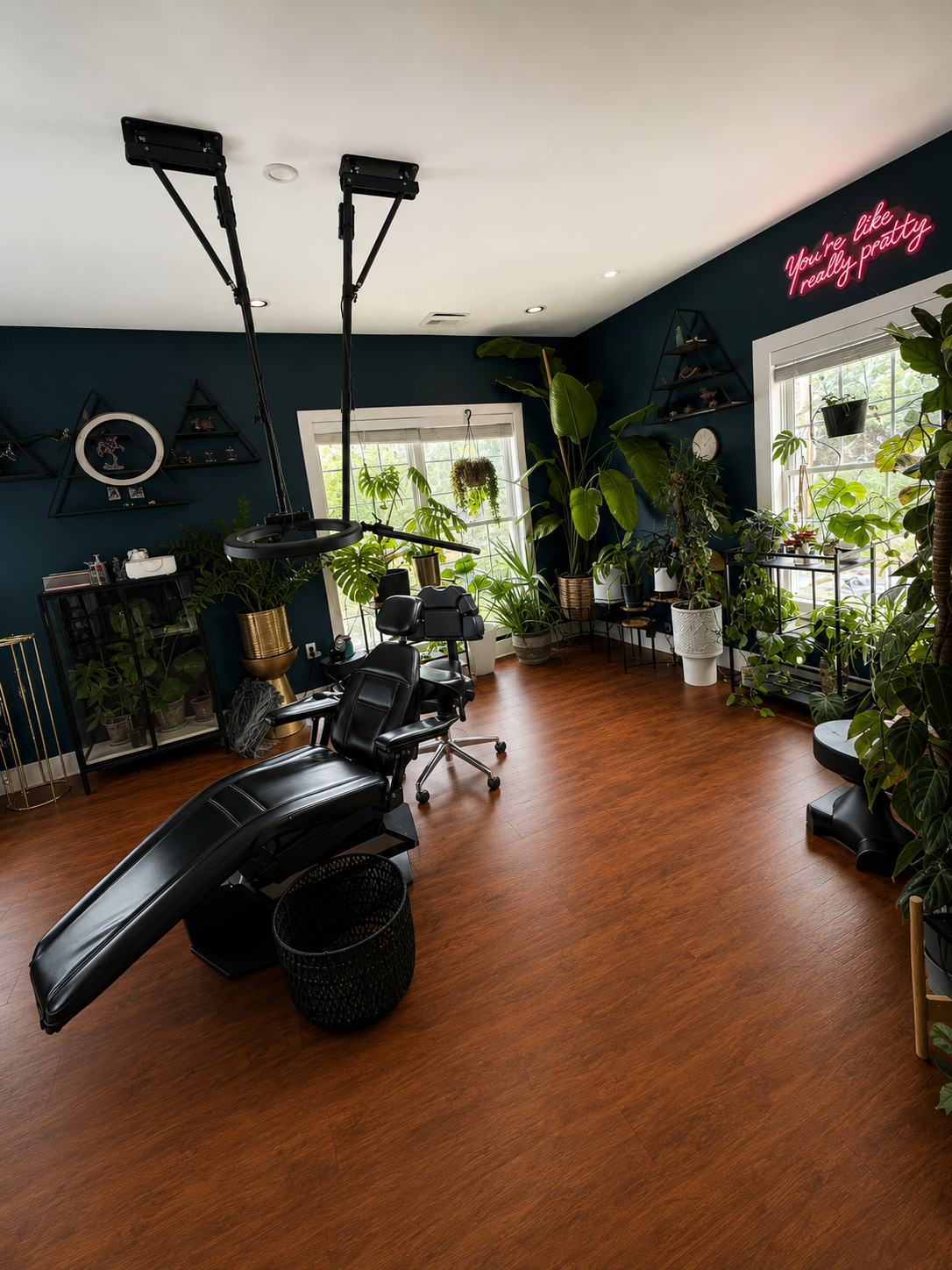 The Brow Babes — custom tattoo suite with neon sign and lush plants